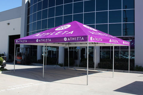 Purple Athleta-branded canopy tent outside corporate building