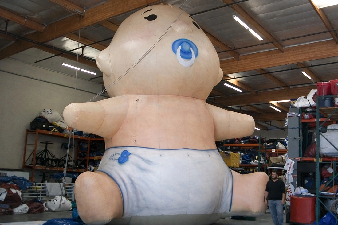 Large giant inflatable baby prop installed indoors for display and promotional environments
