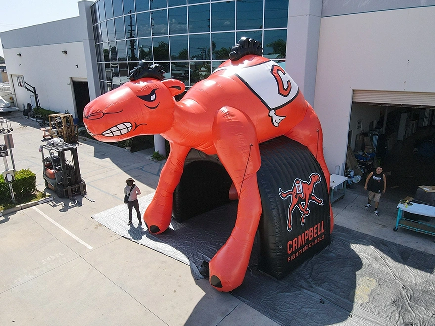 A powerful inflatable tunnel featuring the Campbell camel mascot, designed for college football entrances and team branding.