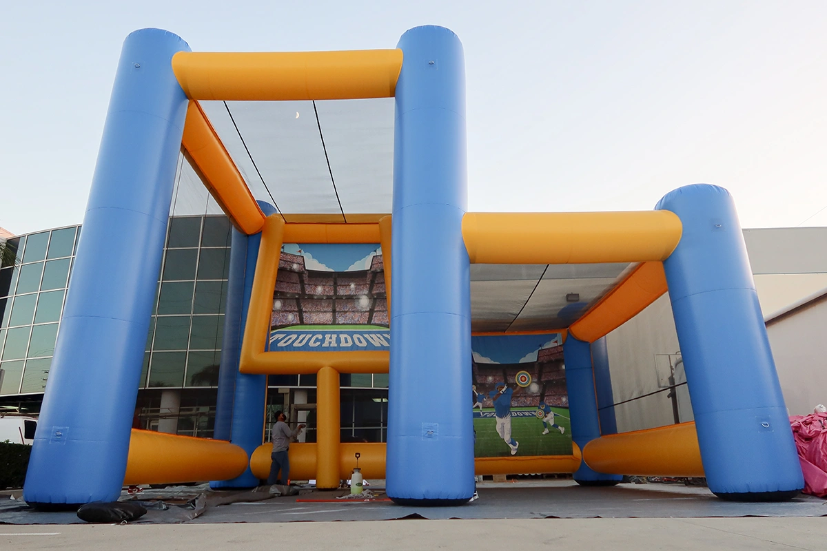 Custom inflatable football tunnel used for interactive sports challenges at events and fan activations