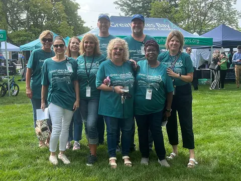Large 10x20 canopy with a group of people at a community event, showcasing a custom pop-up tent.