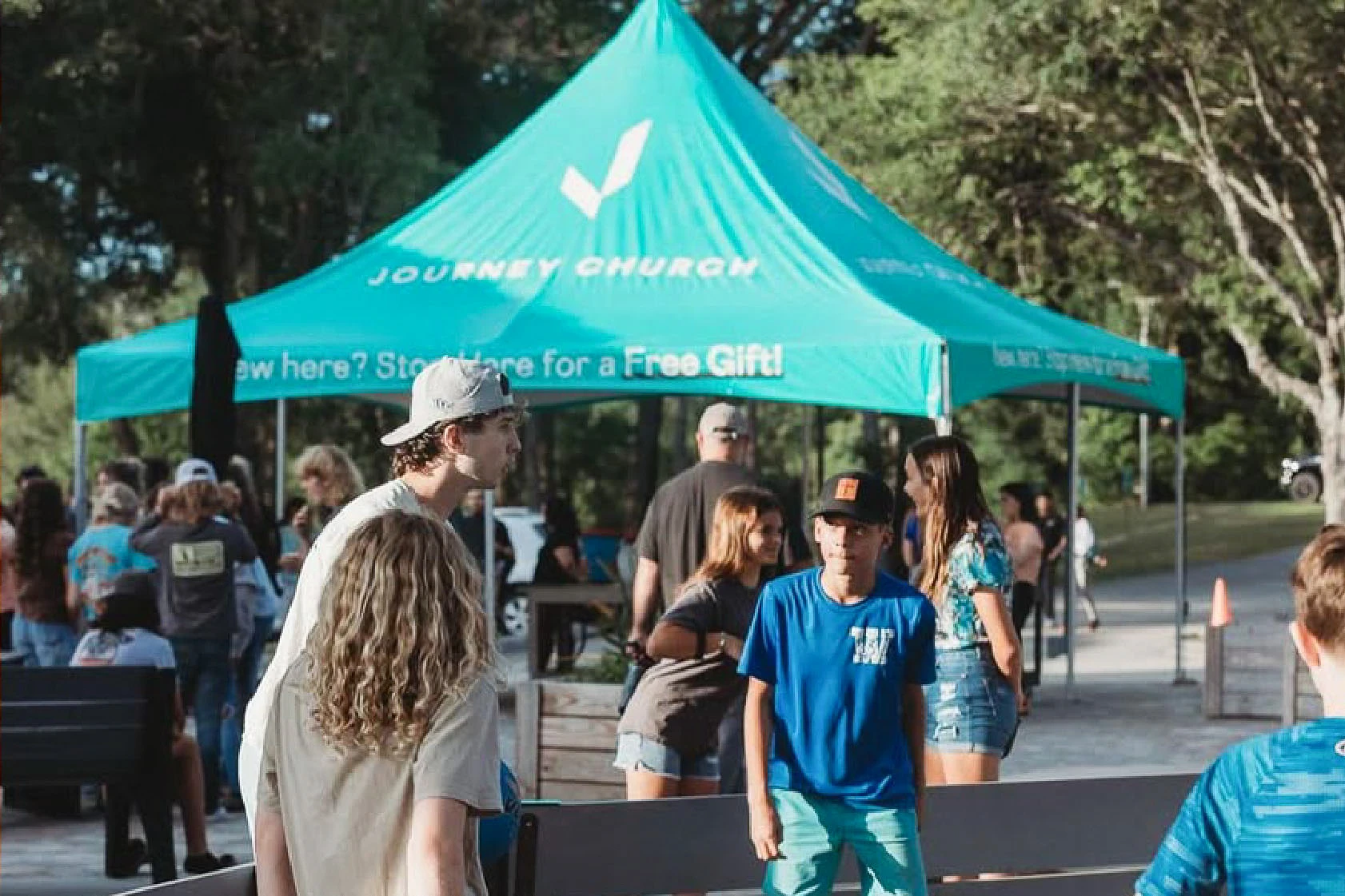 Custom pop up canopy with Journey Church branding used for outdoor outreach and event registration.
