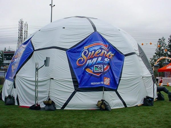 White inflatable dome lounge with Sueno MLS branding set up on a soccer field for a tournament hospitality area.