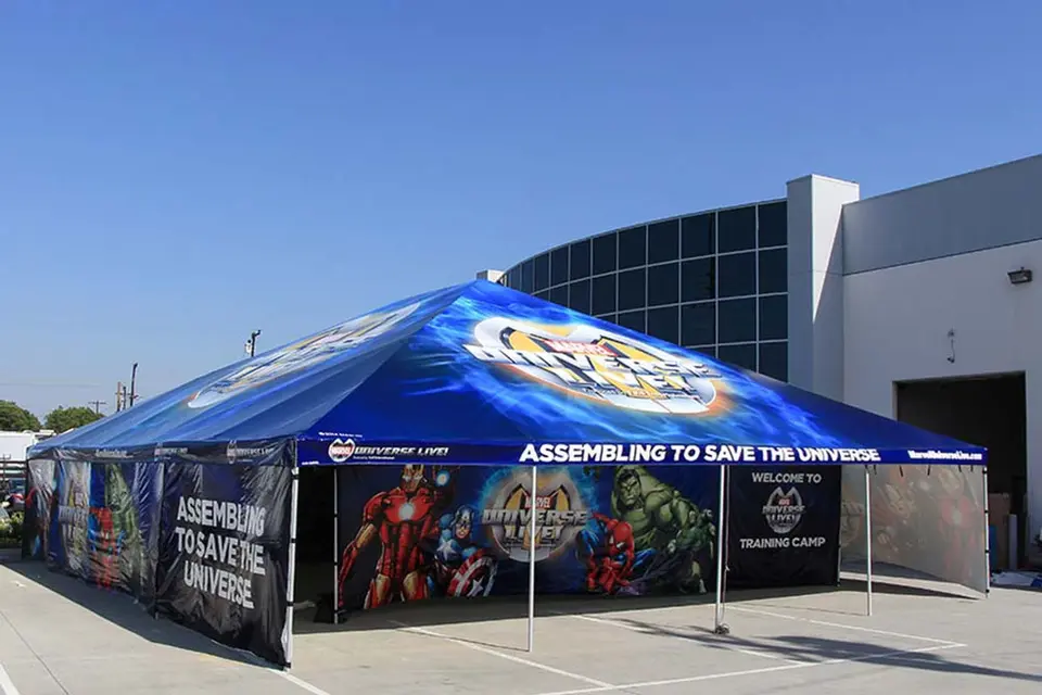 Custom 20x30 canopy tent with full Marvel branding and printed walls used at themed youth training event