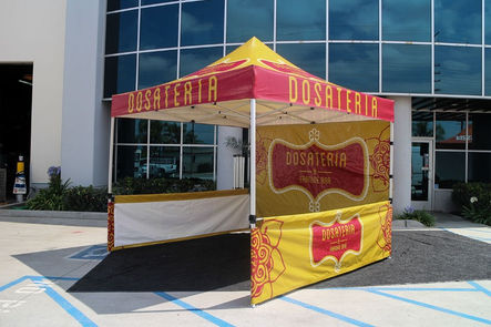 Custom food booth tent for Dosateria with mesh walls and counter