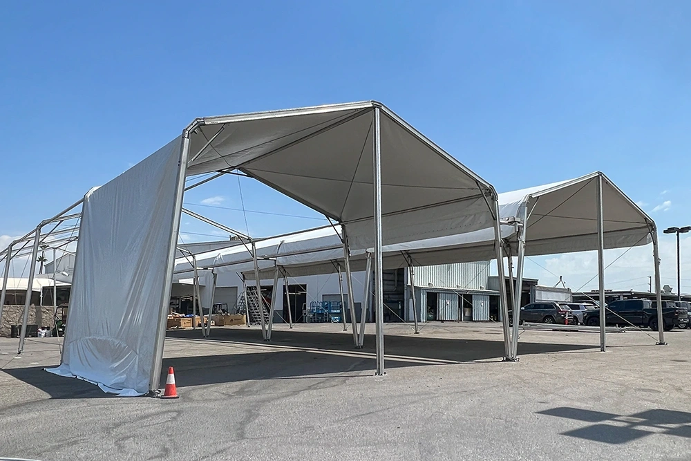 40x80 ft high-ceiling structure tent being assembled for commercial and event use.