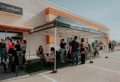 Momentum Church 10x20 custom canopy used for a welcome event outside a modern building.