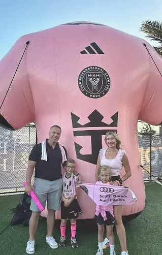 Custom inflatable pink jersey display for Inter Miami soccer team with fans posing in front.