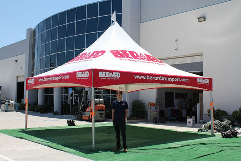 Red Berard Transport canopy tent on turf at outdoor event
