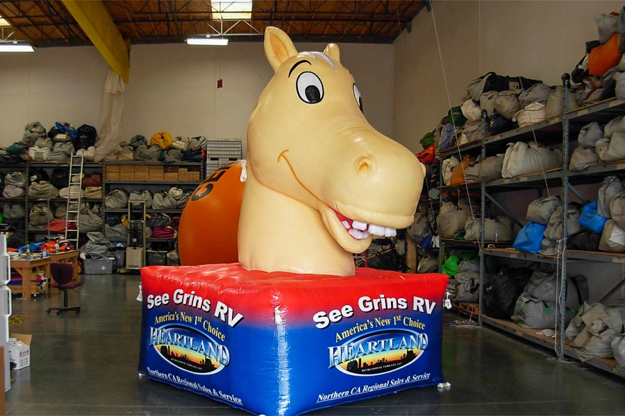 See Grins RV inflatable horse mascot with Heartland branding for showroom display