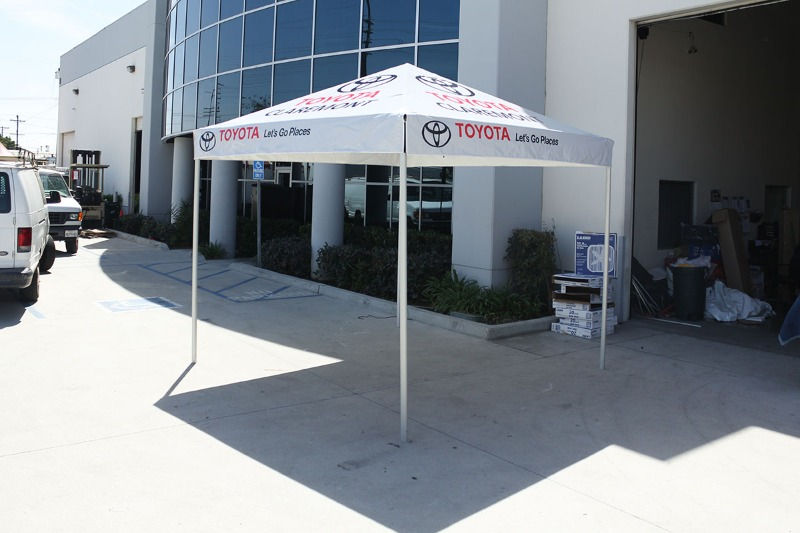 A compact 10x10 pop up tent designed for Toyota, featuring repeated logo placement and tagline messaging—ideal for dealership displays, activations, and customer outreach.