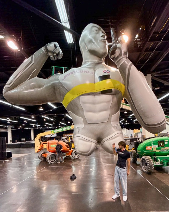 Custom inflatable bodybuilder character mascot used for indoor event promotion and brand activation display.