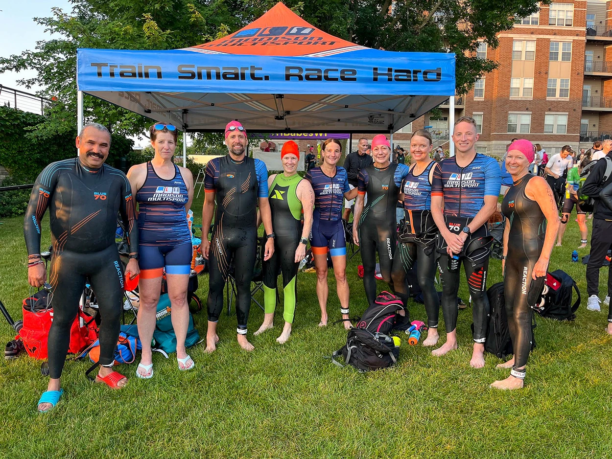 Custom canopy tent promoting a triathlon team at an outdoor event.