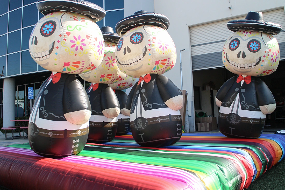 Festival-themed inflatable ring toss character targets on a colorful inflatable base set up outdoors for an interactive event activation.