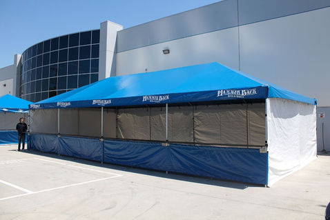 Blue Fisher Pak canopy tent with branded top and sidewalls