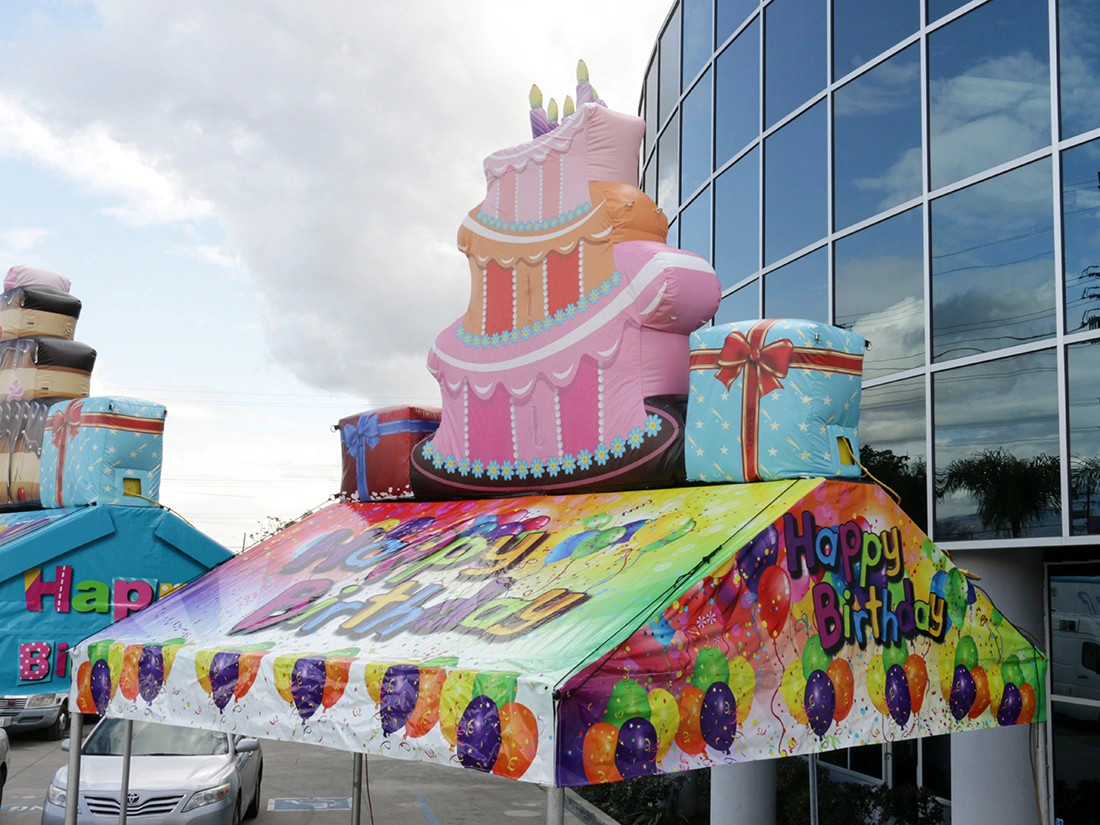 Birthday gable tent with inflatable cake topper used for party and celebration display
