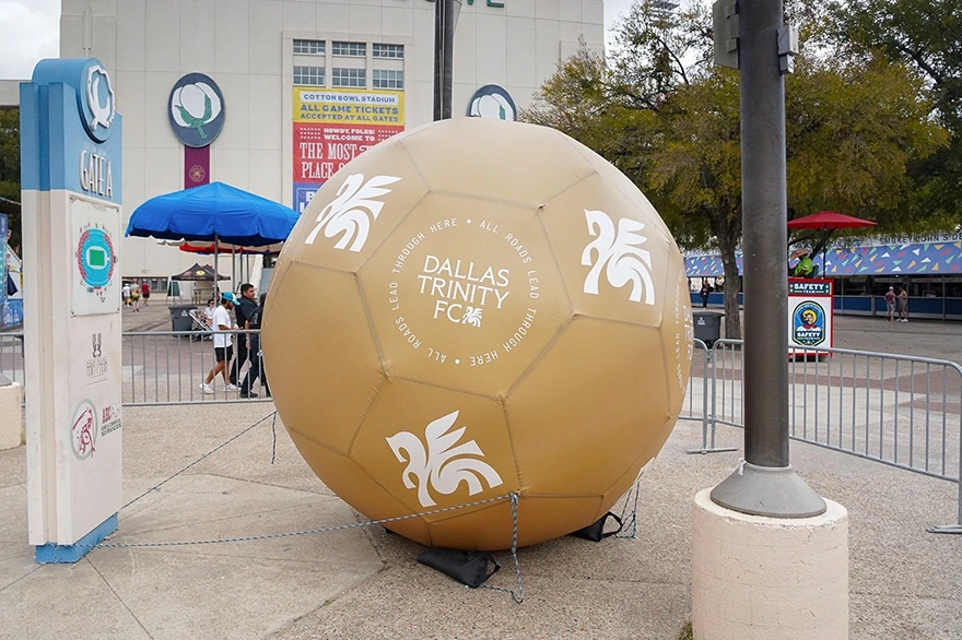 Giant inflatable soccer ball used as an outdoor soccer event display with custom branding