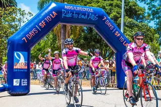 Custom inflatable arch at AIDS Lifecycle event with cyclists passing through