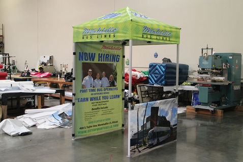 5x5 hiring canopy tent with Montebello Bus Lines branding and Now Hiring signage