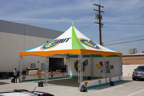 Custom 20x20 high peak tent with Gain branding used at a public outdoor brand event