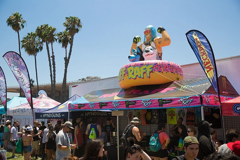 Custom canopy tent with inflatable topper and full print graphics at an outdoor event.