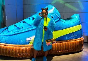 Custom giant inflatable blue shoe display at an indoor branded event