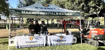 Custom 10x10 canopy for rental equipment company with branded tables