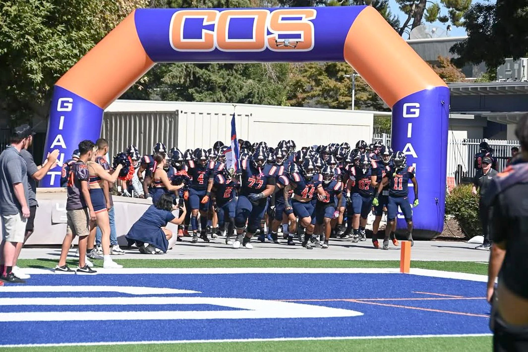 A custom COS football tunnel arch used for team entrances and game-day spirit at College of the Sequoias.