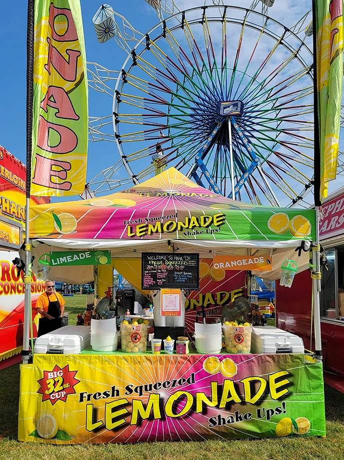 Custom food booth tent with flags.