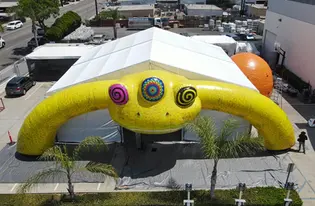 Aerial view of structure tent with inflatable lizard arch and dome props