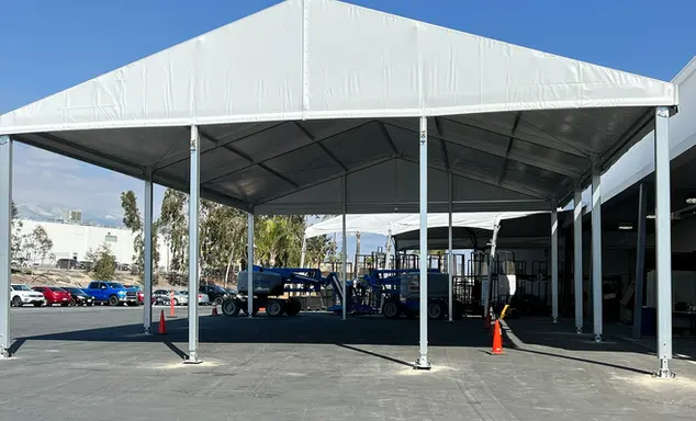 Front view of structure tent with open sides used at industrial worksite