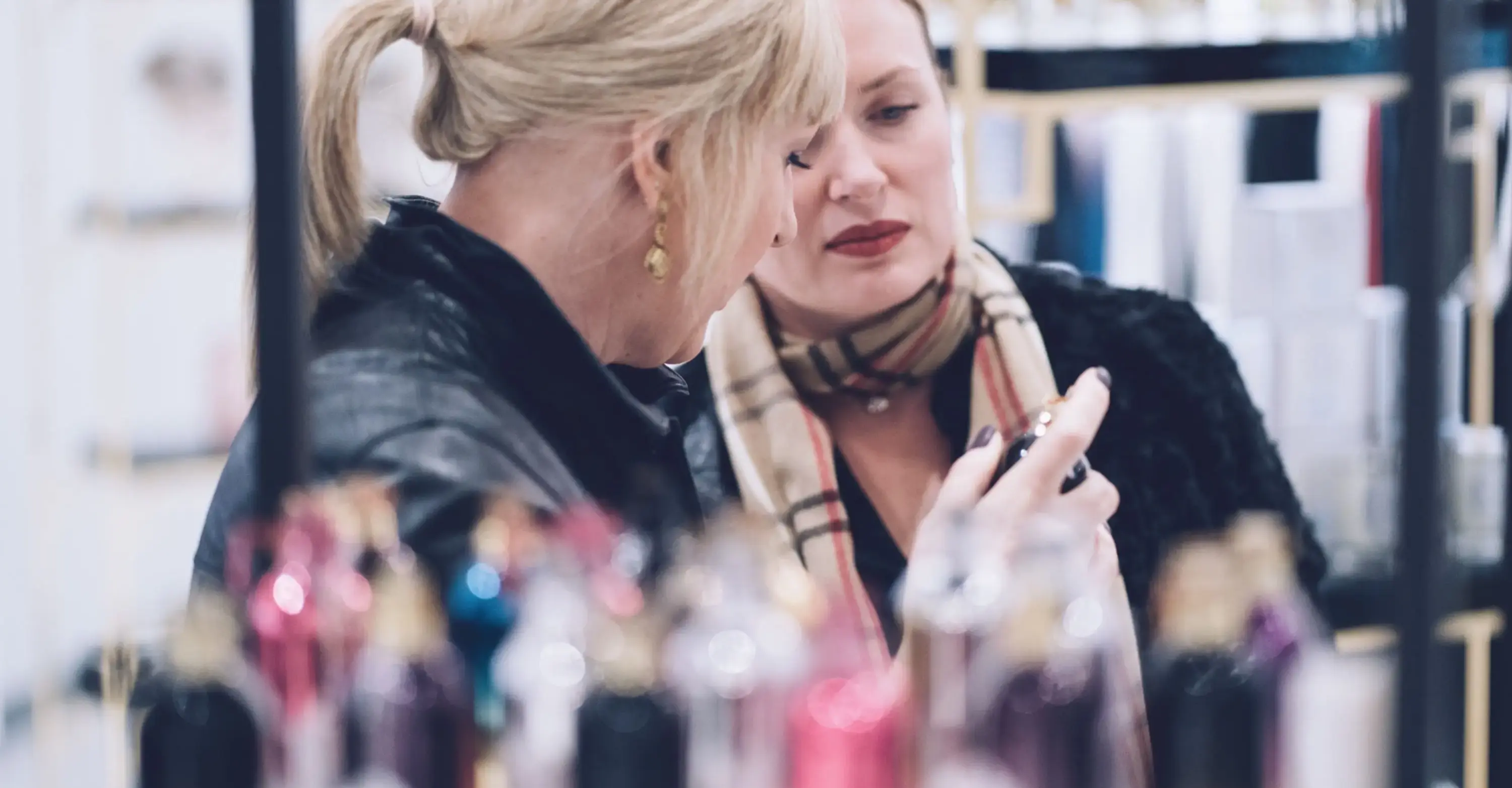 Two women testing fragrances at the counter of La Parfumerie in Raleigh, NC