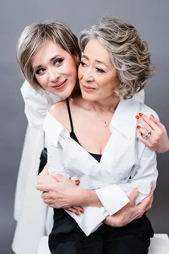 Mother’s Day portrait of an adult daughter hugging her smiling mother, elegant family gift image for Mother’s Day blog post about luxury perfume gifts.