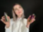 Founder of La Parfumerie USA Viktoriya holding niche perfume bottles against a black background in Raleigh boutique blog feature image