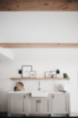 Lisa Clark Design Winnipeg Manitoba interior design green cabinets beams marble tile farmhouse sink brass faucet floating shelf