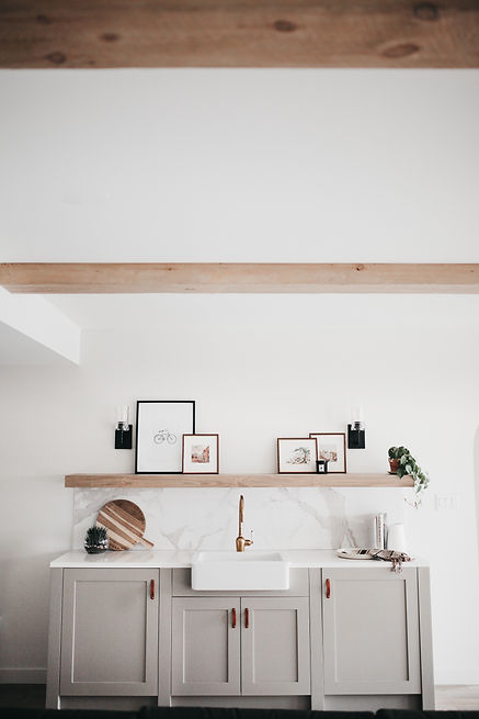 Lisa Clark Design Winnipeg Manitoba interior design green cabinets beams marble tile farmhouse sink brass faucet floating shelf