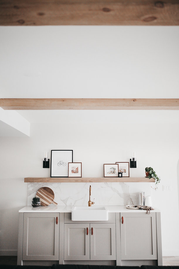 Lisa Clark Design Winnipeg Manitoba interior design green cabinets beams marble tile farmhouse sink brass faucet floating shelf