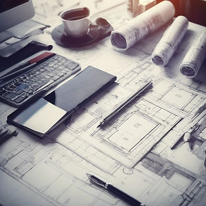 residential Design architectural plan documents on desk .jpg
