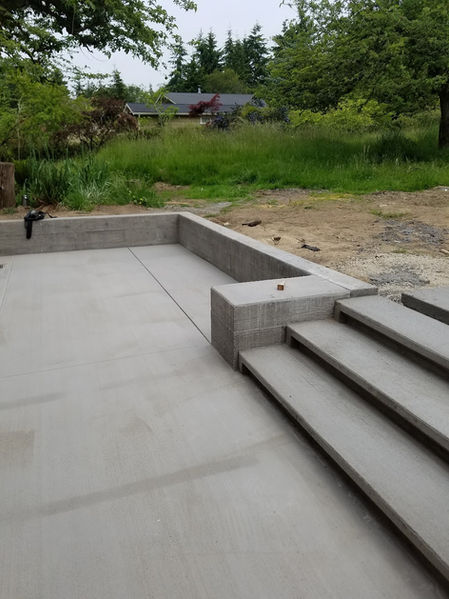 "Pathway made of textured concrete, providing a safe and durable walkway.