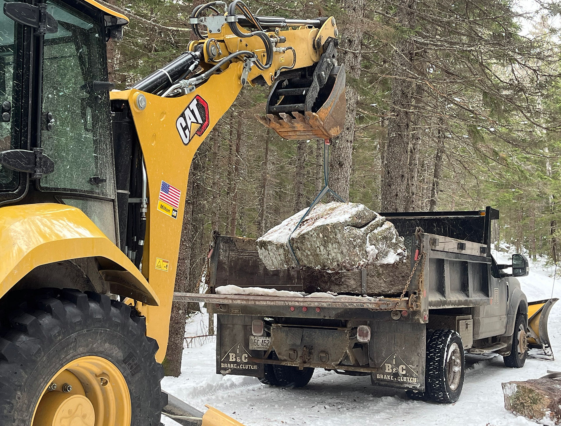 Granite being lifted on to a pick up truck.
