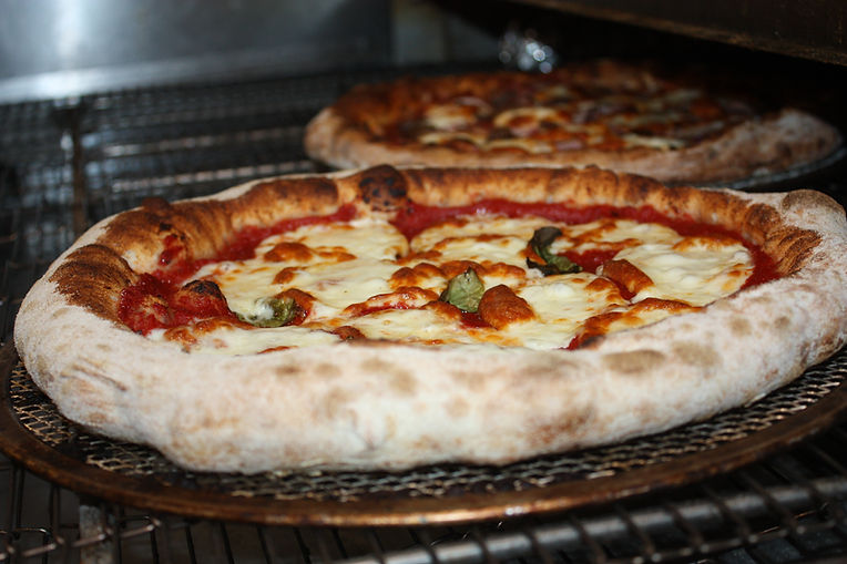 Hand-stretched pizzas in the oven Surrey Hills