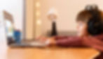 child-wearing-headphones-attending-virtual-coding-class-from-home