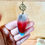 Thumbnail: parrot feather earring with rose charm at metaphysical crystal shop