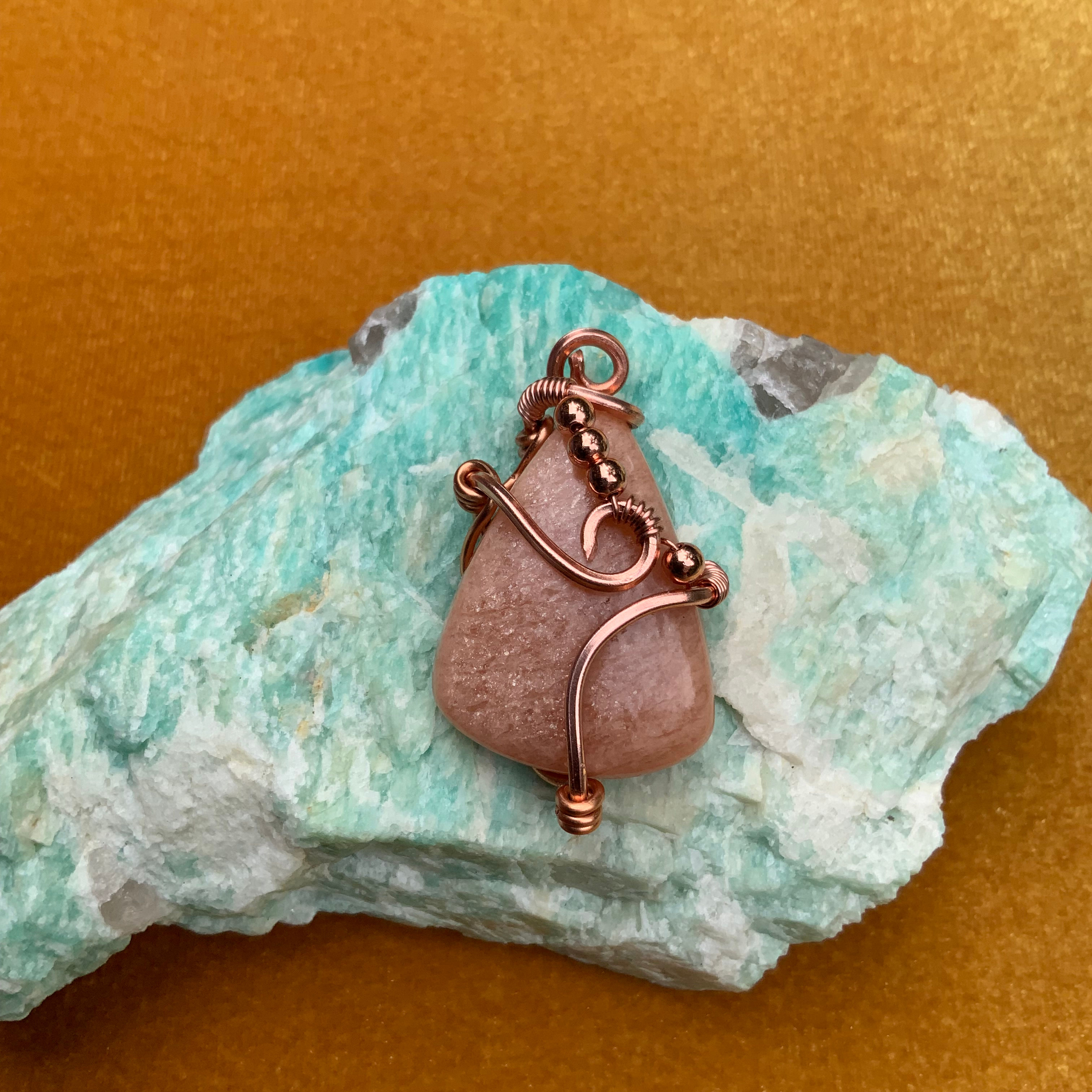 Peach moonstone copper wire wrapped pendant by Sah at metaphysical crystal shop in Canada
