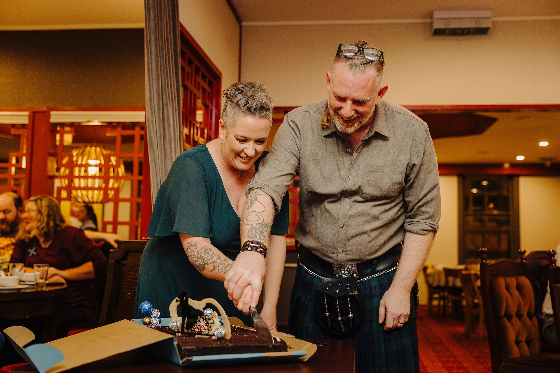 Couple cutting their cake, vow renewal reception