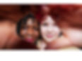 Two teen girls, one African American and the other White, making a heart-shape over their faces