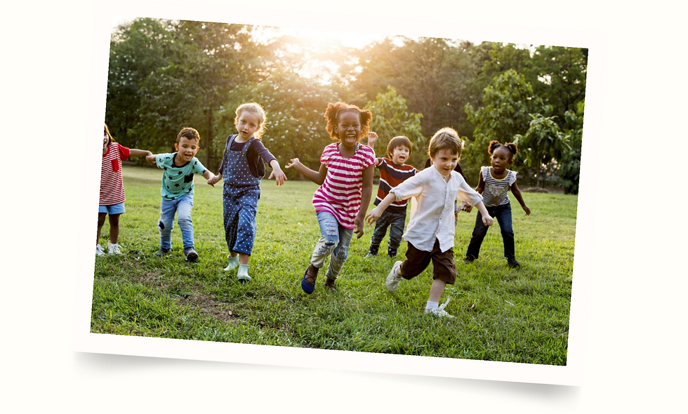 diverse group of kids running together on grass