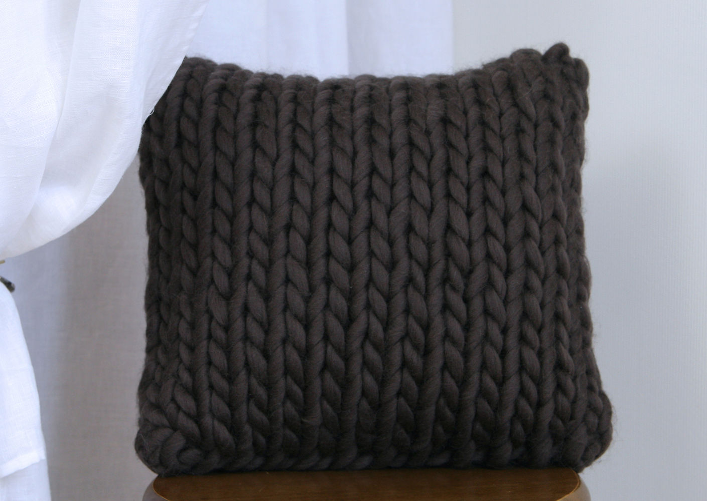 Декоративна в'язана подушка коричневого відтінку