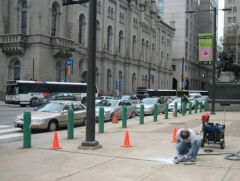 Technician precision cutting concrete in metro area