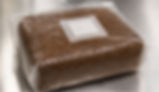 A close-up overhead shot of a freshly prepared and sterilized supplemented sawdust block inside a clear polypropylene bag